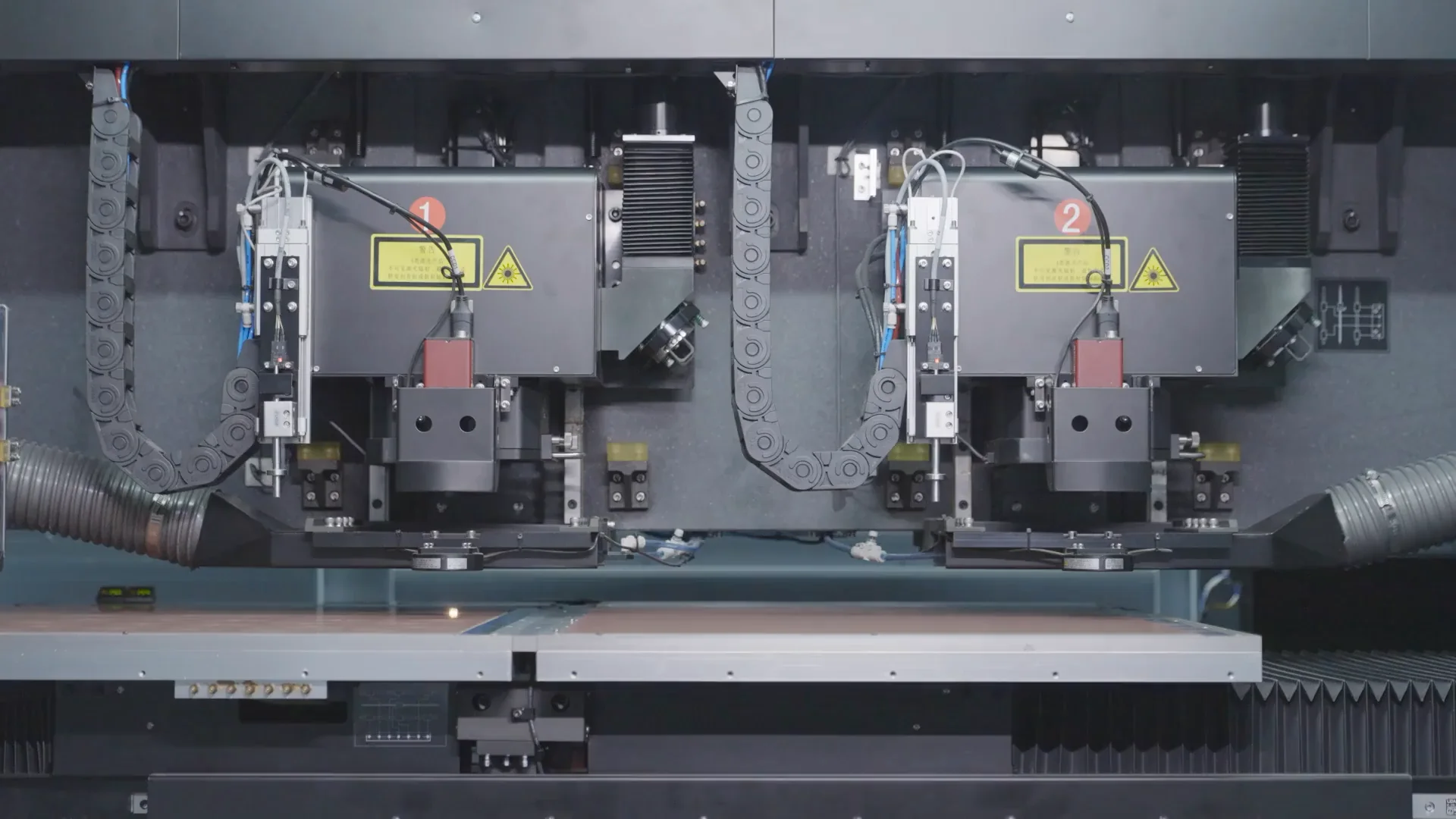 Laser drilling heads above a PCB production worktable