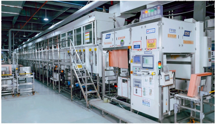 Vertical continuous copper plating equipment on a PCB production floor.